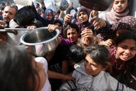 Palestinians wait to receive food cooked by a charity kitchen, in Beit Lahia, northern Gaza Strip, April 3, 2025. [Mahmoud Issa/Reuters] (Reuters)
