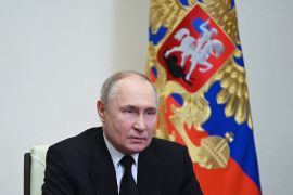 In this pool photograph distributed by the Russian state agency Sputnik, Russia's President Vladimir Putin delivers his address in Moscow on March 23