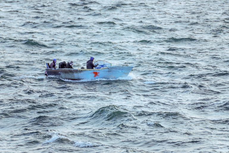 Fishermen at sea in a boat.