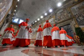 Cardinals walking in a row.