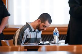 Hadi Matar sits with his head bowed in a courtroom.