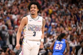 Julian Strawther (3) of the Denver Nuggets smiles after scoring over Shai Gilgeous-Alexander of the Oklahoma City Thunder