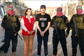 An image from video shows Edan Alexander, Hamas fighters and a Red Cross representative in southern Gaza [Al Jazeera]