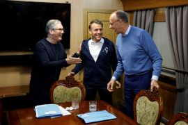 France's President Emmanuel Macron, Britain's Prime Minister Keir Starmer and German Chancellor Friedrich Merz hold a trilateral meeting on board a train to Ukraine